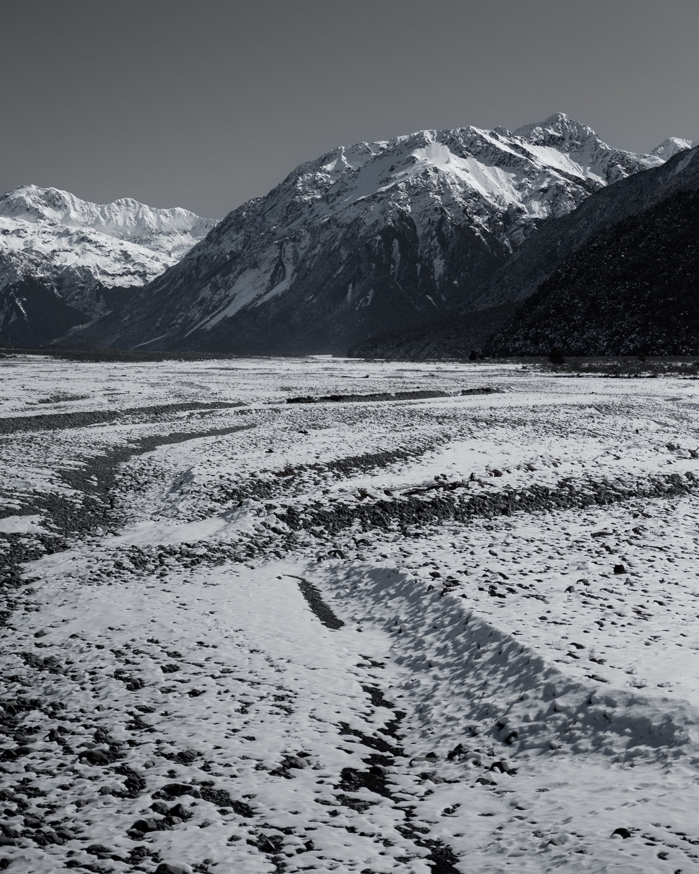 Snow-covered mountains above a broad valley