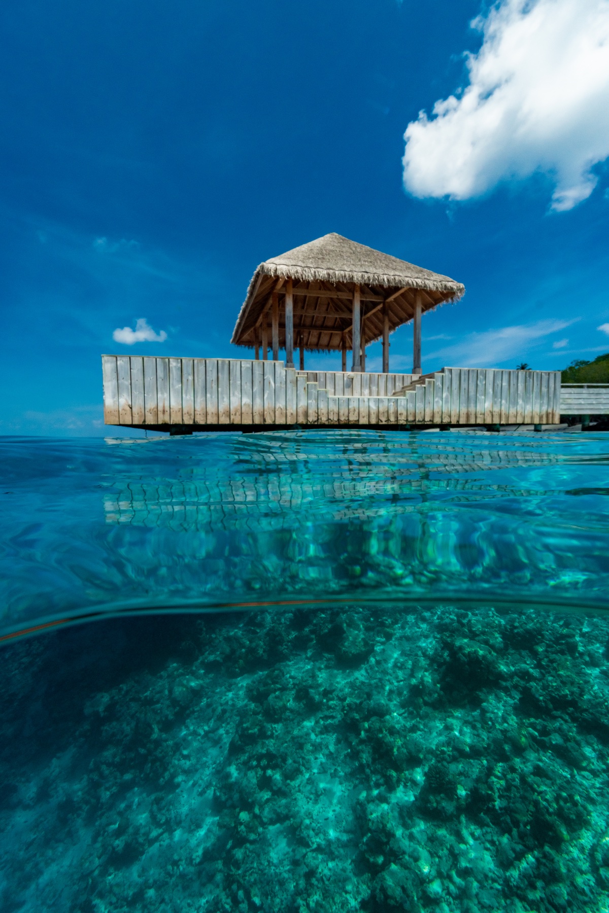 A pavilion above clear turquoise lagoon water