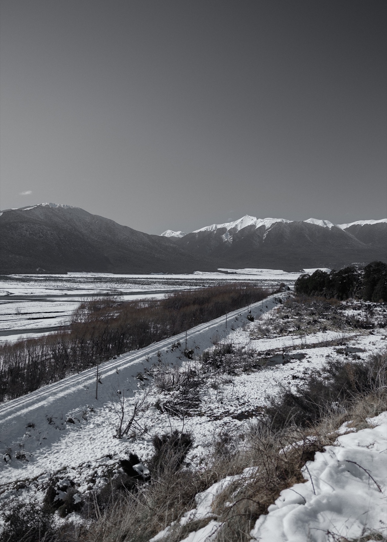Snow-covered valley framed by mountains